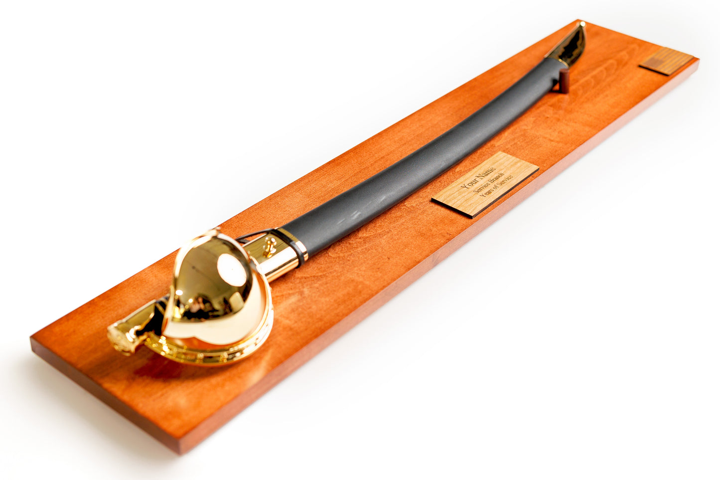 U.S. Navy Chief Cutlass Display in Cognac finish with a personalized engraved nameplate, shown with a sword.