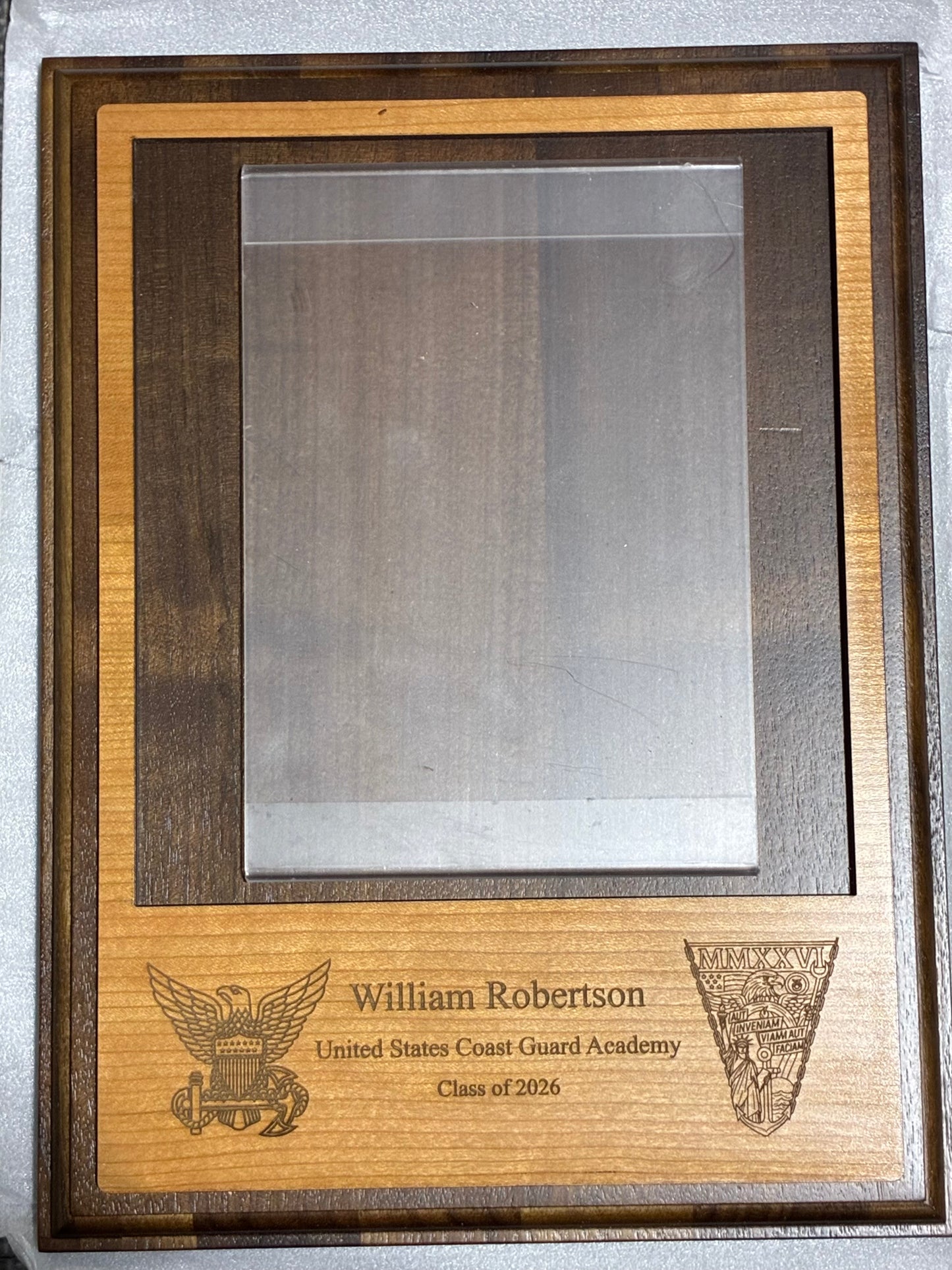 Wooden photo plaque for a 5x7 photo that is exclusively for the USCGA Class of 2026.  This fundraiser has an engraved class crest